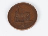 an image of a coin with a statue on it on a white surface