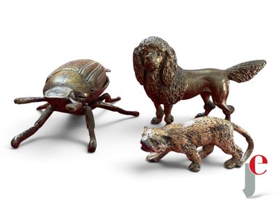 three figurines of animals and a turtle on a table