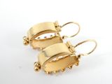 pair of gold tone earrings on a white background