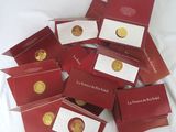 a pile of red cards with gold coins on them