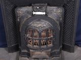 an old cast iron fireplace with a blue background