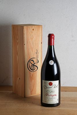 a bottle of wine sitting next to a wooden box