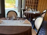 a table set with wine glasses and napkins in a restaurant