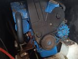 a blue engine in the back of a truck