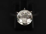a close up of a diamond ring on a black background