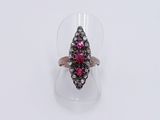 a close up of a pink and white diamond ring on a clear surface