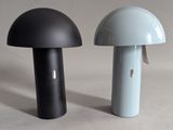 two black and white lamps sitting next to each other on a table