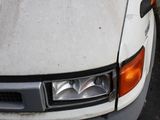 a white truck that is parked on the side of the road