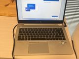 a laptop that is sitting on a desk with a power cord