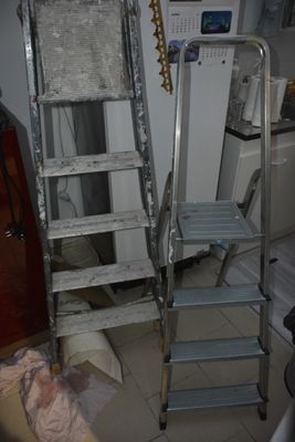 a ladder that is leaning against the wall in the kitchen