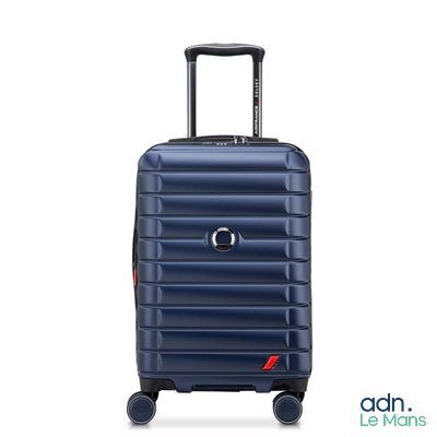 the blue suitcase is on wheels and has a handle