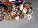 a pile of assorted key chains and other items on a table