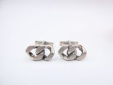 pair of silver cufflinks with a knot design on them