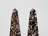 a pair of black and white marble obelisks on a white background