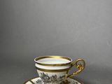 a cup and saucer on a saucer on a table