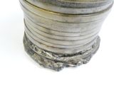 a silver cup that is sitting on a white surface