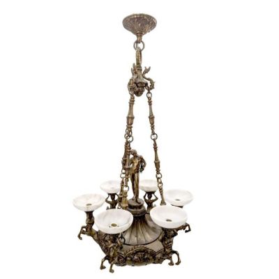 a brass chandelier with five white glass shades hanging from the ceiling