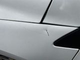 a close up of a white car with a broken door handle