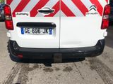 a white van with red and white stripes parked in a parking lot