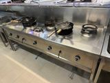 many pots and pans on the stove in the kitchen