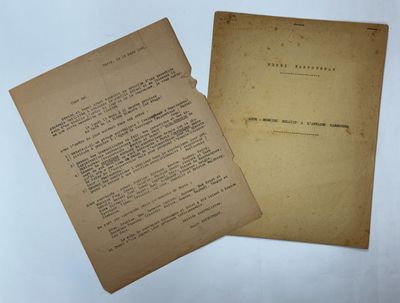 two old papers sitting on top of a table next to each other