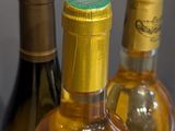 three bottles of wine sitting on a wooden table