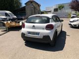 a white car parked in a parking lot next to other cars