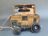 a small wooden box with a telephone on top of it