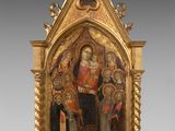 un autel richement décoré et plaqué or, sur lequel figure une peinture représentant la Vierge entourée d'anges