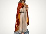 a statue of a woman wearing a crown standing on top of a cloud