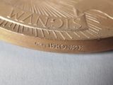 a close up of a gold medal on a white surface
