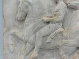 relief of a man on a horse with a woman on a horse
