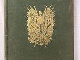 un vieux livre vert avec un aigle doré sur la couverture