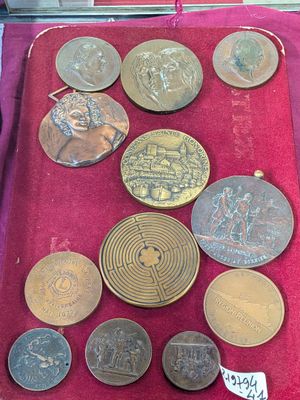 a lot of coins that are on display in a case