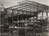 a black and white photo of a train station under construction
