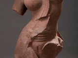 an image of a statue of a woman with a breast on a stand