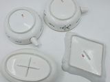 four pieces of white pottery on a white table