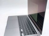 a silver laptop computer sitting on top of a white table