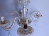a white chandelier with two lights attached to it