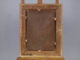 an old wooden easel with a painting on top of it