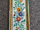 a close up of a plate with flowers and leaves on it