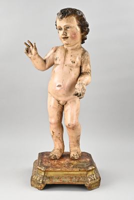 statue of a child with a raised hand on a wooden base