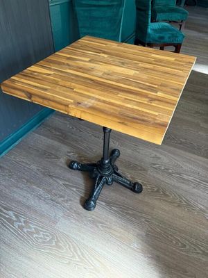 a small table with a wooden top on a wooden floor