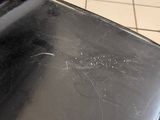 a dirty seat on a black chair on a tiled floor