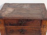 a small wooden table with three drawers on it