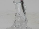 a glass figurine of a fish on a stand