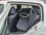a car that has a tire in the back seat of it