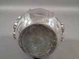 a close up of a silver object on a table