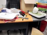 a desk with a chair and a lot of papers on it
