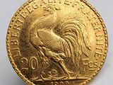 l'image d'une pièce d'or ornée d'un coq